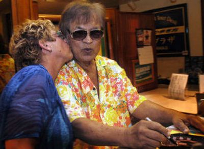 
Don Ho, right, gets a kiss from a fan after his nightly show at the Waikiki Beachcomer Hotel  in Honolulu.
 (Associated Press / The Spokesman-Review)