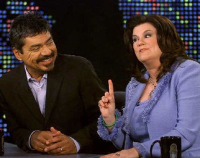 
Actor, comedian George Lopez and his wife, Ann, wearing a bracelet promoting organ donation, are interviewed by talk show host Larry King on 