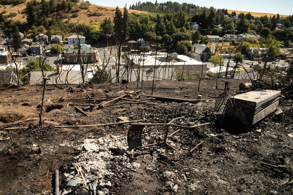 People clean up in Colfax after the fire Sept. 8, 2020 The