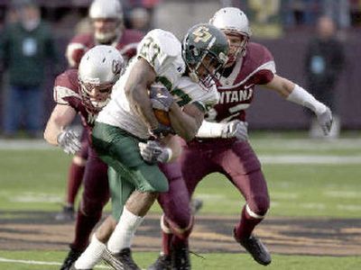 
Cal Poly running back James Noble is corralled by Montana inside linebacker Shane MacIntyre.
 (Associated Press / The Spokesman-Review)