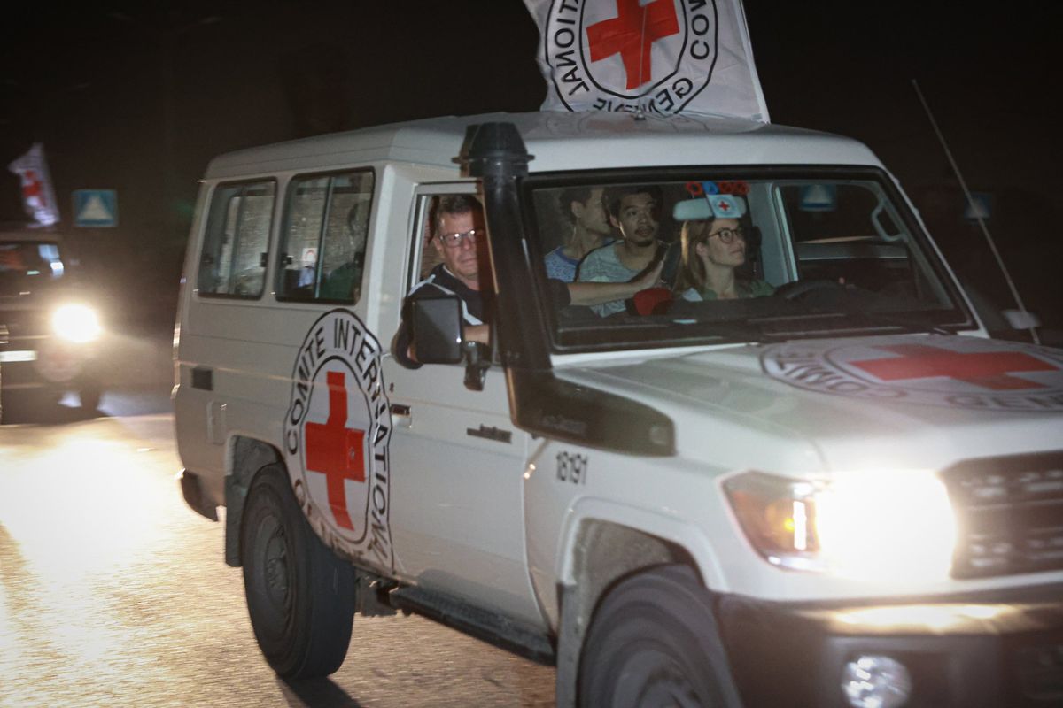 International Red Cross vehicles carry hostages released by Hamas across the Rafah border point in the Gaza Strip towards Egypt on Nov. 25, 2023. MUST CREDIT: Loay Ayyoub for The Washington Post.  (Loay Ayyoub/For The Washington Post)