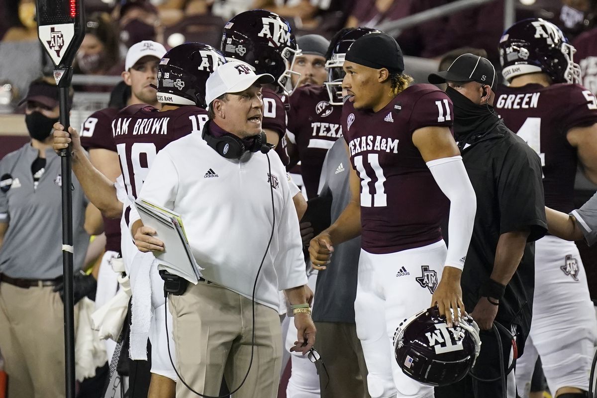 Texas A&amp;M coach Jimbo Fisher, left, talks with quarterback Kellen Mond during last Saturday’s victory against visiting Vanderbilt.  (David J. Phillip)
