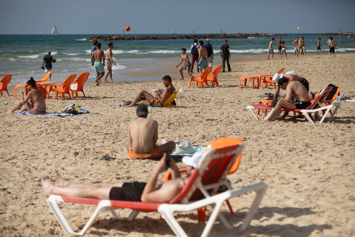 People hang out at a beach in Tel Aviv, Israel, after Iran’s drone and missile attack on Israel overnight on Sunday. Hundreds of cruise missiles and UAVs sent by Iran overnight were mostly intercepted and destroyed by Israel’s Defence System and some en route by the U.S. and other allies. Some minor damage has been reported but no fatalities.  (Amir Levy)