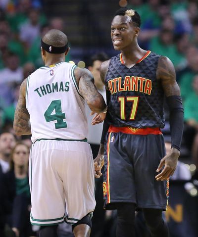 Atlanta’s Dennis Schroder, right, reacts toward game officials after Boston’s Isaiah Thomas made contact with him during Friday’s Game 3. (Curtis Compton / Associated Press)