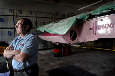 
Murdo Cameron, of Coeur d'Alene stands near the hydroplane that he is using as a mold to build a replica of the Miss Spokane hydroplane that raced in the 1960's and 70's.
 (Kathy Plonka / The Spokesman-Review)