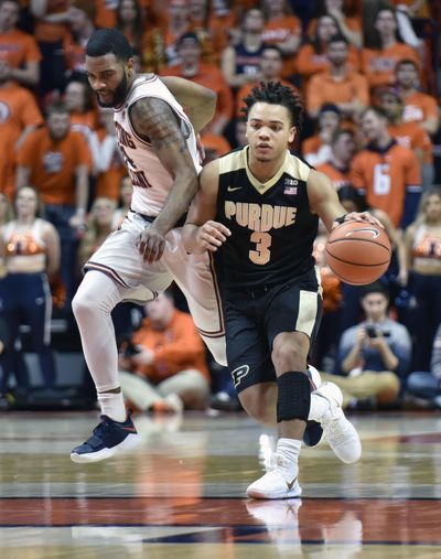 Purdue’s Carsen Edwards dribbles past past Illinois’ Mark Alstork on Thursday night in Champaign, Ill. Edwards scored a career-high 40 points in the Boilermakers’ 93-86 victory. (Stephen Haas / Associated Press)