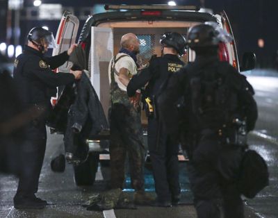 FILE - In this Jan. 20, 2017, file photo, a protester, center, is arrested as a crowd marches in protest through the streets of Portland, Ore., following Donald Trump's presidential inauguration. (Dave Killen / Associated Press)