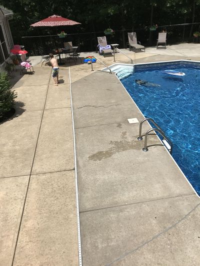 The concrete around this swimming pool is two different shades. There are several ways to make it look much better and change the color at the same time. (Tim Carter)