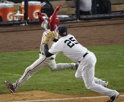 ORG XMIT: WS305 New York Yankees' Mark Teixeira tags out Philadelphia Phillies' Jimmy Rollins near first base in the first inning of Game 1 of the Major League Baseball World Series Wednesday, Oct. 28, 2009, in New York. (AP Photo/Eric Gay) (Eric Gay / The Spokesman-Review)