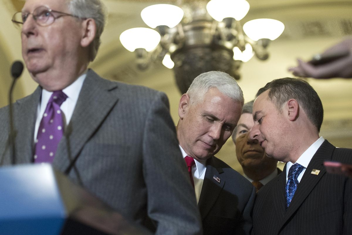 Vice President-elect Mike Pence talks with Reince Priebus, chief of staff for President-elect Donald Trump, right, as Senate Majority Leader Mitch McConnell, of Kentucky, speaks at a Capitol Hill news conference Wednesday, Jan. 4, 2017. Priebus said Sunday that Trump indeed has accepted that Russia was responsible for hacking during the election. (Cliff Owen / AP)