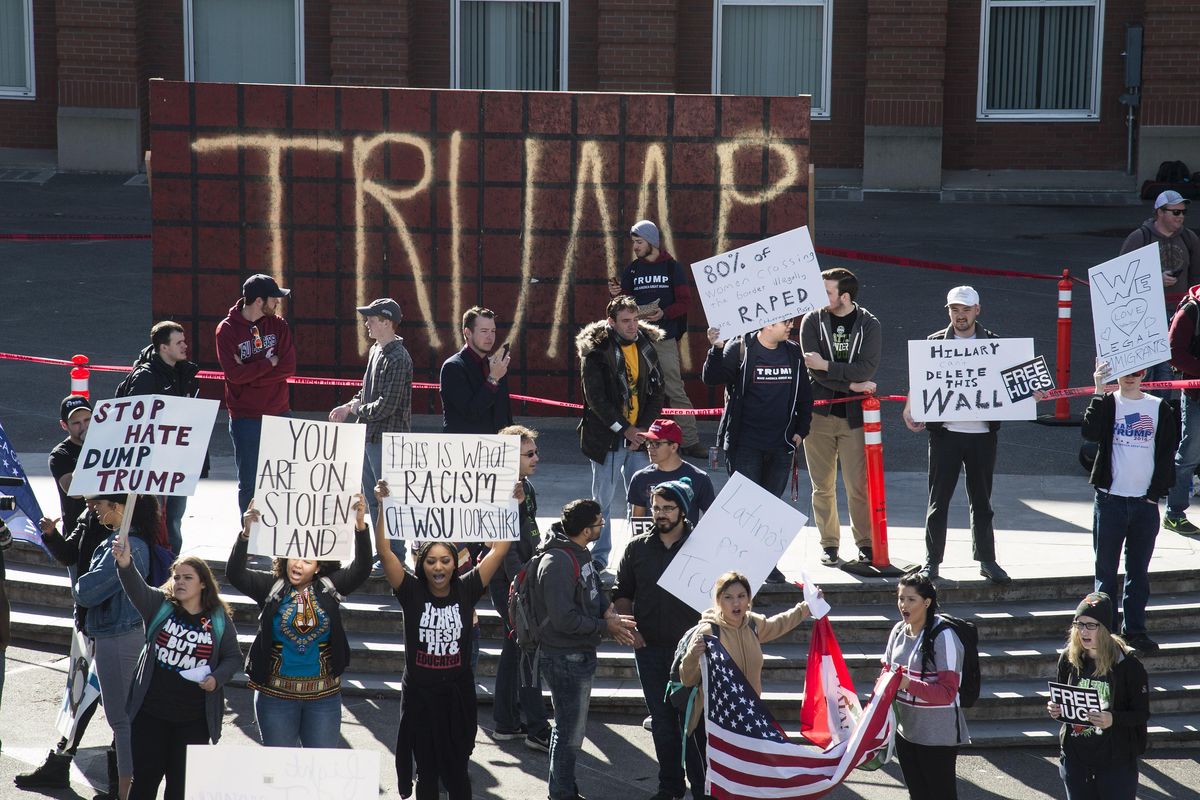Unity Rally counter protesters face off with about a dozen Trump supporters during the WSU College Republicans Trump Wall demonstration and Unity Rally counter protest on the WSU campus, Oct. 19, 2016, in Pullman, Wash. (Colin Mulvany / The Spokesman-Review)