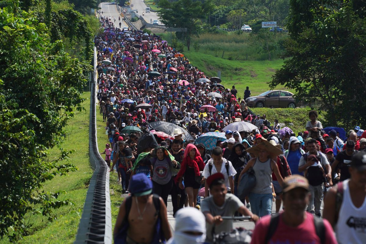 FILE - Migrants arrive in Villa Comaltitlan, Chiapas state, Mexico, Oct. 27, 2021, as they continue their journey through Mexico to the U.S. border. The Biden administration struck agreement with Mexico to reinstate a Trump-era border policy next week that forces asylum-seekers to wait in Mexico for hearings in U.S. immigration court, U.S. officials said Thursday.  (Marco Ugarte)