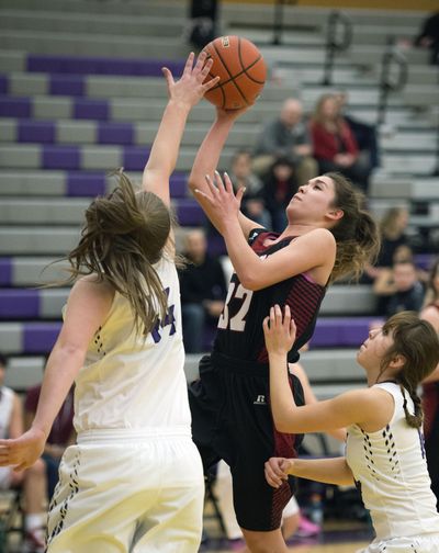 North Central forward Megan Dean (32) takes a shot as Rogers forward Kendall Tillet (44) defends during the first half of a girls high school basketball game at Rogers High School on Tuesday. Dean, a senior, leads the team in scoring at 14.1 a game. (Colin Mulvany / The Spokesman-Review)