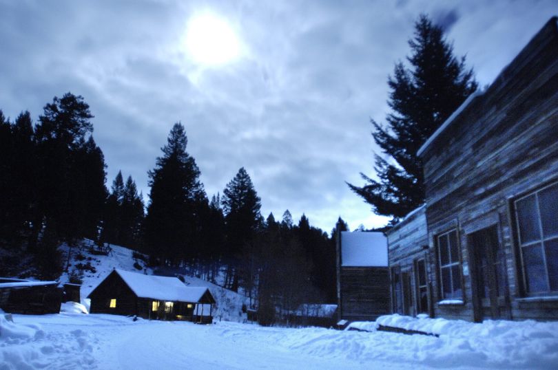 A full moon illuminates Garnet Ghost Town, Mont., on Dec. 30, drawing long shadows on the snow in the dead of winter. Associated Press photos (Associated Press photos / Independent Record)