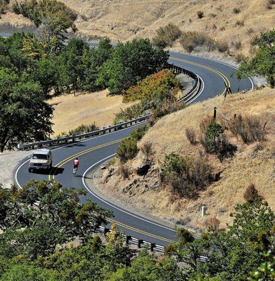 In this May 2014 photo, a bicyclist rides down Dead Indian Memorial Road near Ashland, Ore. (Jamie Lusch / Associated Press)