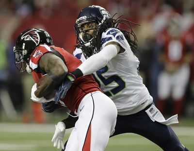 The NFL is looking into why the Seahawks did not disclose a knee injury Richard Sherman, right, played with for several games. (David Goldman / Associated Press)