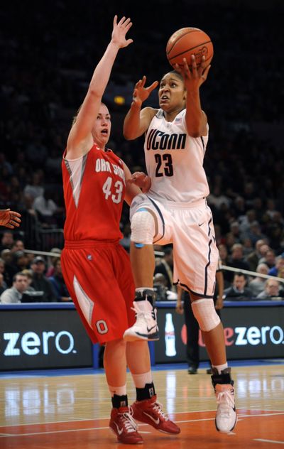 UConn’s Maya Moore, shooting against Sarah Schulze, scored 22 points.