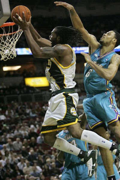 
Sonics' Chris Wilcox dunks against Tyson Chandler for two of his 22 points Tuesday night. 
 (Associated Press / The Spokesman-Review)