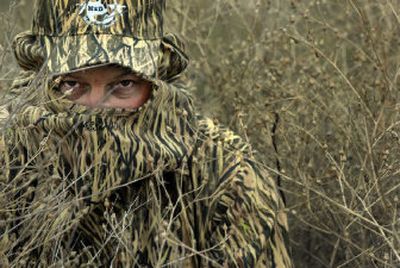 
Roger Libby of M2D Camo demonstrates the effectiveness of the company's new grassland camouflage pattern. The company's founder decided on the new pattern while hunting in the grasslands of Washington, where traditional camouflage patterns don't blend in. 
 (Jed Conklin the Spokesman-Review / The Spokesman-Review)