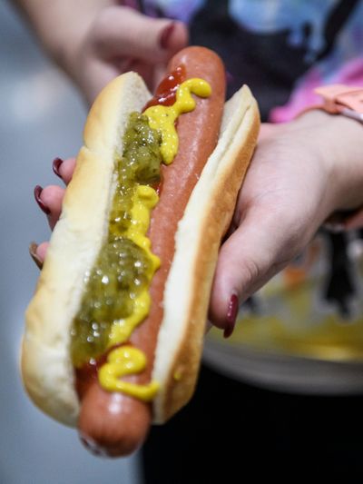 Kimberly Hills displays the size of her $1.50 hot dog during Costco's grand opening day in Evansville, Indiana June 28, 2019.  (SAM OWENS/ COURIER & PRESS / USA)