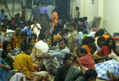 
People displaced by the tsunamis sit inside a relief camp in a temple at Varichikudi, about 125 miles south of Madras, India, on Monday.
 (The Spokesman-Review)
