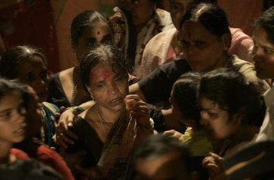 The wife of Balasaheb Bhosale cries at his funeral in Mumbai, India, on Thursday. Balasaheb Bhosale was a police official who died in the antiterrorism operation at a railway station.   (Associated Press / The Spokesman-Review)