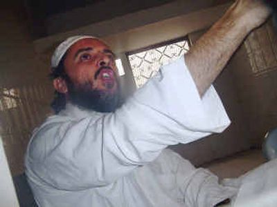 
 Jamal al-Badawi shouts and shakes his fist in the air  in Sanaa, Yemen, upon hearing the court's decision Wednesday to sentence him to death for participating in the October 2000 attack against the American warship USS Cole.
 (Associated Press / The Spokesman-Review)