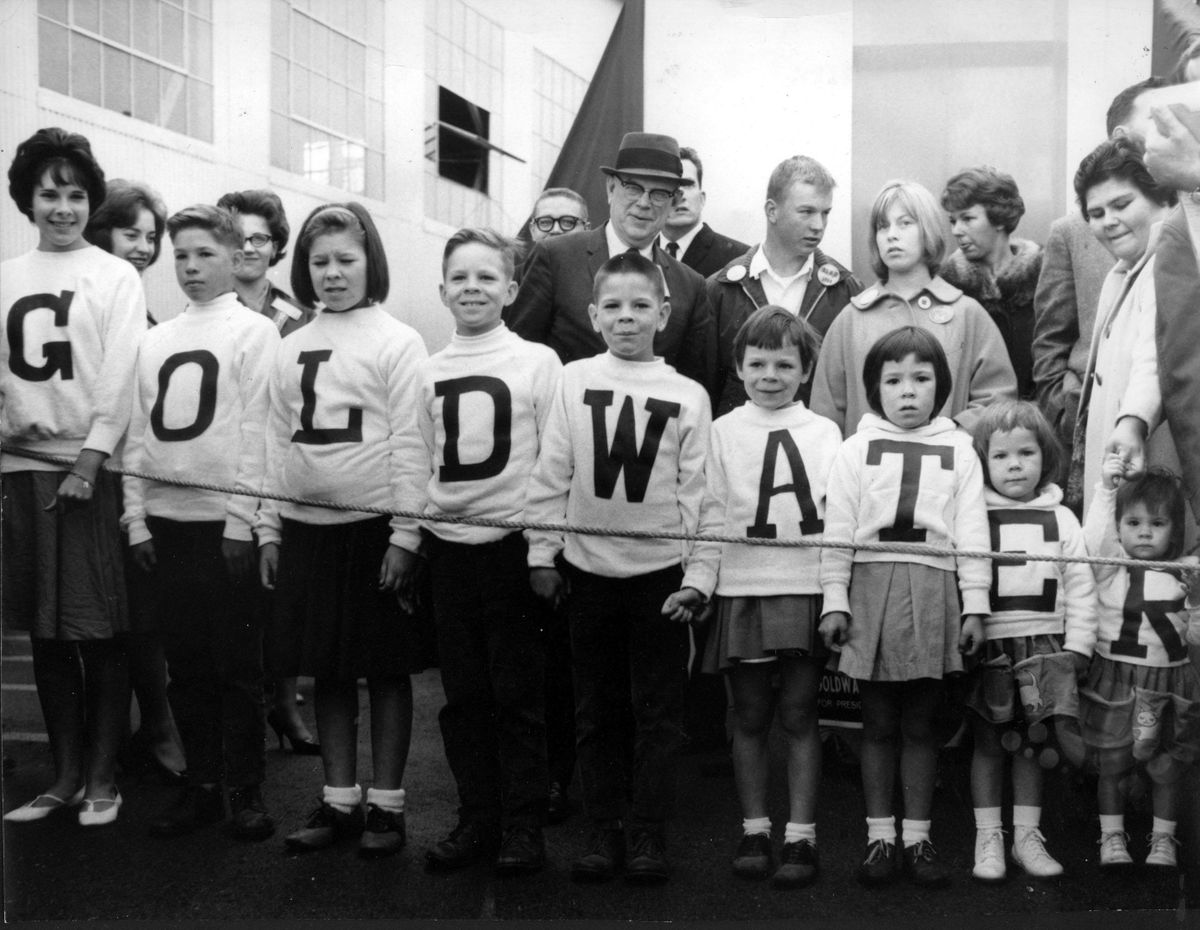 October 1964: The nine Mendenhall children attend a rally for presidential candidate Barry Goldwater in Spokane. From left are Janet, Bobby, Merrian, Danny, Jeff, Molly, Colleen, Ann and Eileen. Their mother, Paula Mendenhall, is pictured at the far right holding Eileen’s hand. (The Spokesman-Review Photo Archive)