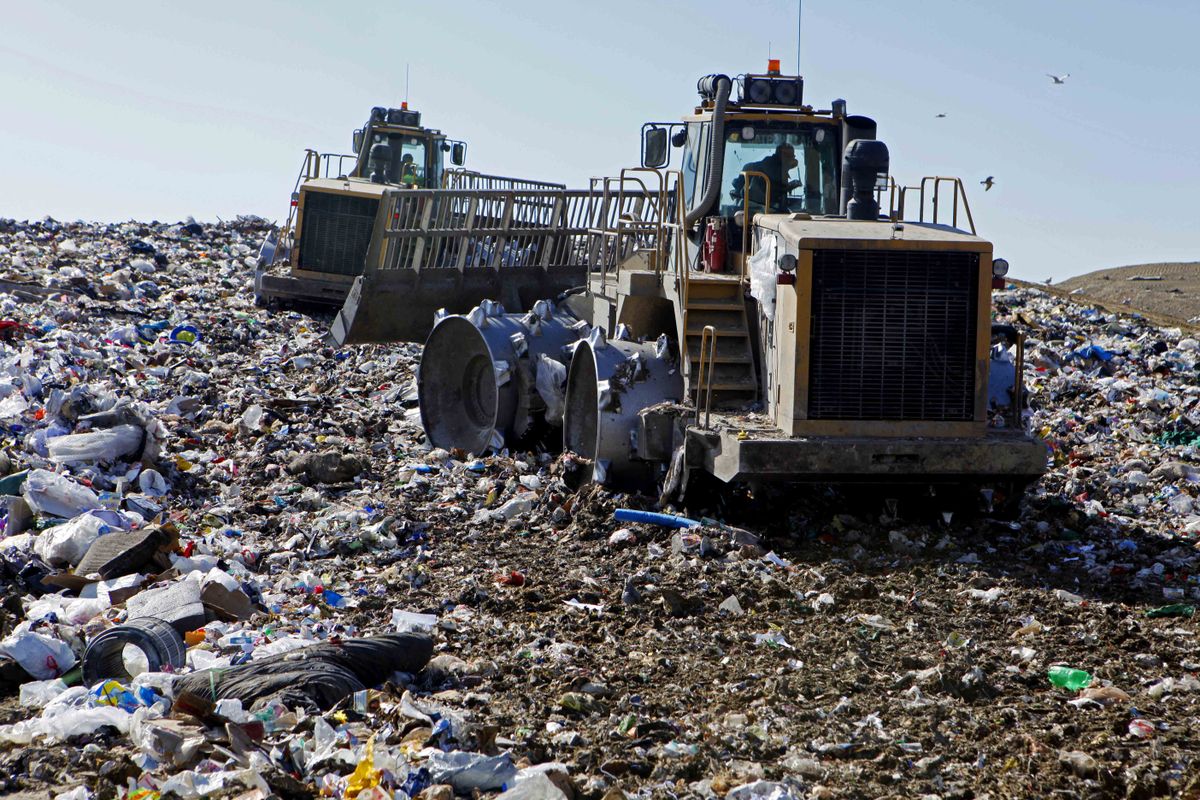 Workers mash trash last month at a Solid Waste Authority of Central Ohio landfill April 8  in Grove City, Ohio.  (Associated Press / The Spokesman-Review)