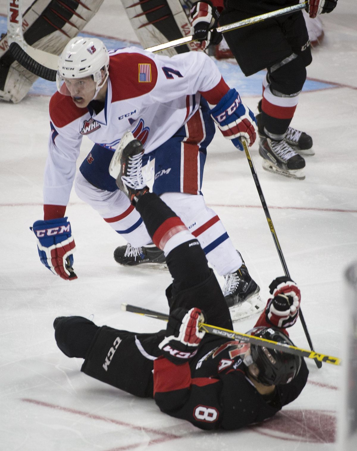 Spokane Chiefs defenseman Evan Fiala, left, knocks Prince George left wing Chase Witala (8) down during the first period. The Chiefs lost 6-0. (Colin Mulvany / The Spokesman-Review)