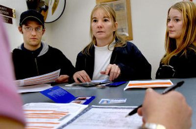 
In preparation for a family cruise, Gail Conces, center,  and her kids Don and Kelly Savage apply for passports at the County Recorder office in Coeur d'Alene last week. Though passports aren't required for cruises originating in the U.S., many are recommending them.
 (Kathy Plonka / The Spokesman-Review)