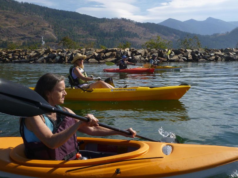 Kayakers paddle past from the drift yard boat launch into the Clark Fork Delta and the northeast end of Lake Pend Oreille. Scotchman Peak is in the upper right. (RICH LANDERS richl@spokesman.com)