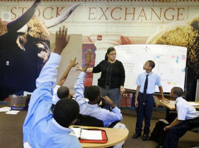 
 Connie Moran teaches class at the Ariel Community Academy in Chicago on Tuesday. The school, sponsored by an African American mutual fund company, gives kids real money to invest as a class that they collect when they graduate.
 (Associated Press / The Spokesman-Review)
