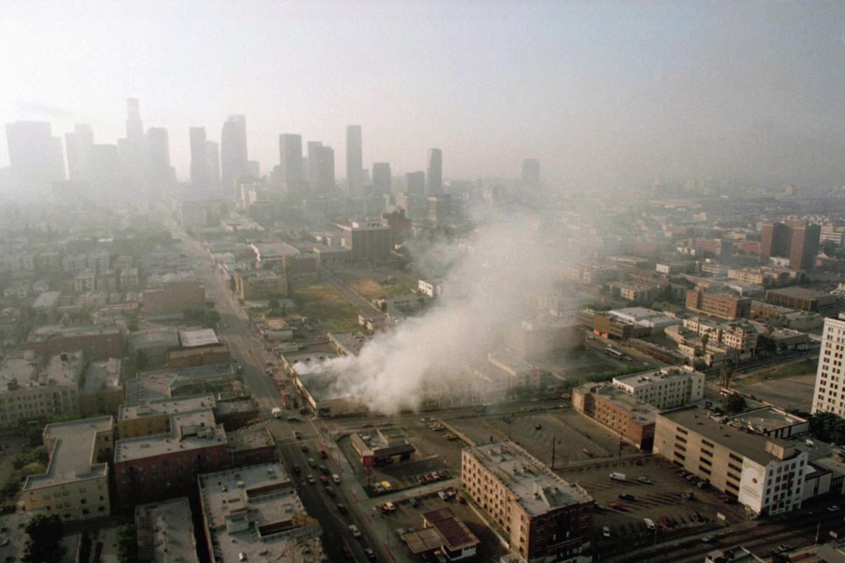 In this April 30, 1992 file photo, smoke rises from a shopping center burned by rioters in Los Angeles after four police officers had been acquitted of the 1991 beating of motorist Rodney King. Six documentaries about the 1992 Los Angeles riots are being released to mark the 25th anniversary of the most destructive civil disturbance in US history. Most are coming to TV this month. (PAUL SAKUMA / Associated Press)
