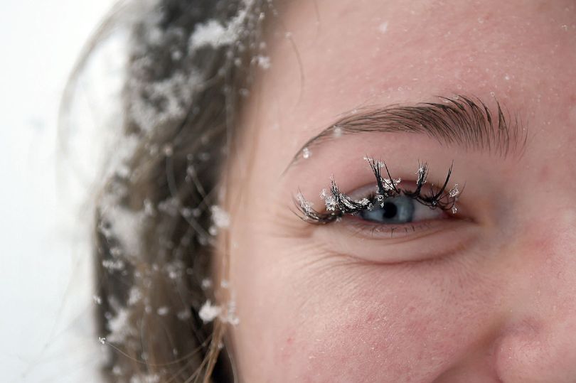 Snow flakes clinged to Courtney Pettoello's eyelashes as she prepared to jump into Lake Coeur d'Alene on Sunday, Jan. 1 2017 during the annual Polar Bear Plunge on Sanders Beach in Coeur d'Alene. (Kathy Plonka/SR photo)