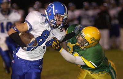 
Coeur d'Alene wide receiver Calvin Peterson, left, tries to fend off Hawks defender Chase Roberts during the teams' game at Lakeland High School. 
 (Tom Davenport/ / The Spokesman-Review)