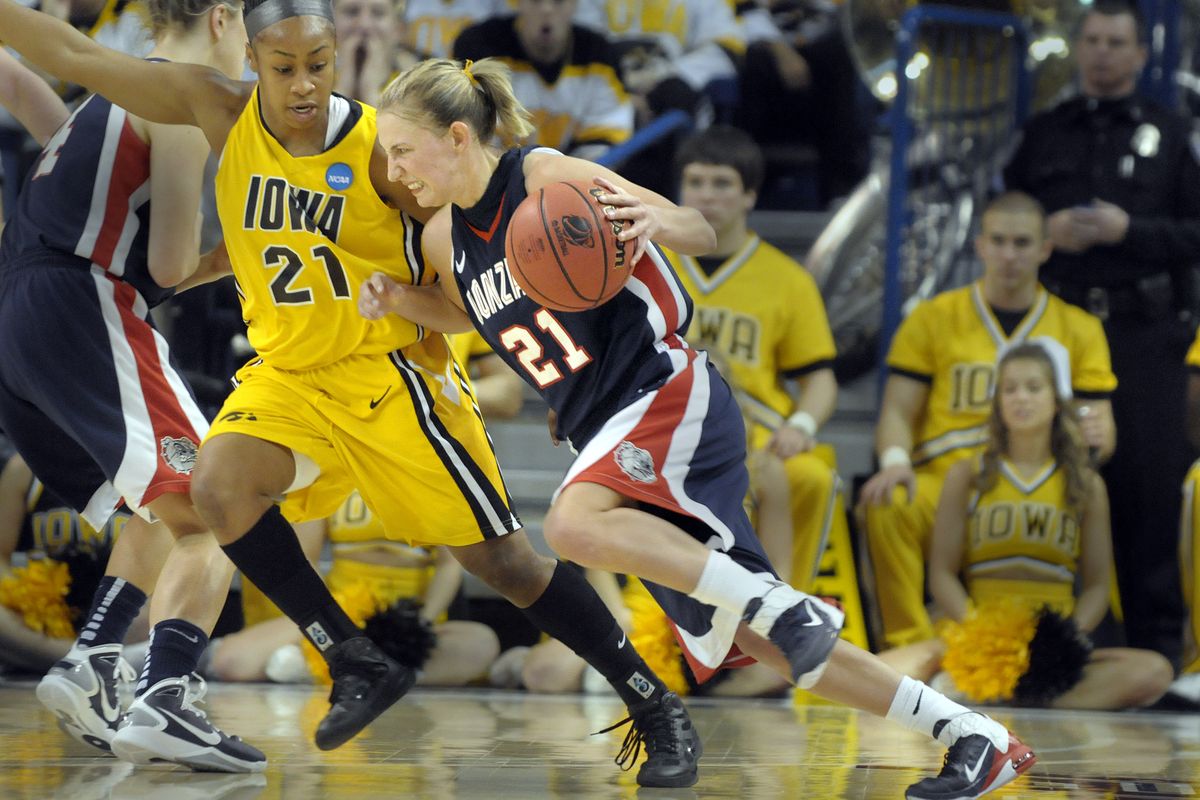 Courtney Vandersloot grimaces as she tries to drive around the defense of Kachine Alexander of Iowa during first half action in their NCAA game in Spokane, Wash. on Saturday, March 19, 2011. (Christopher Anderson / The Spokesman-Review)