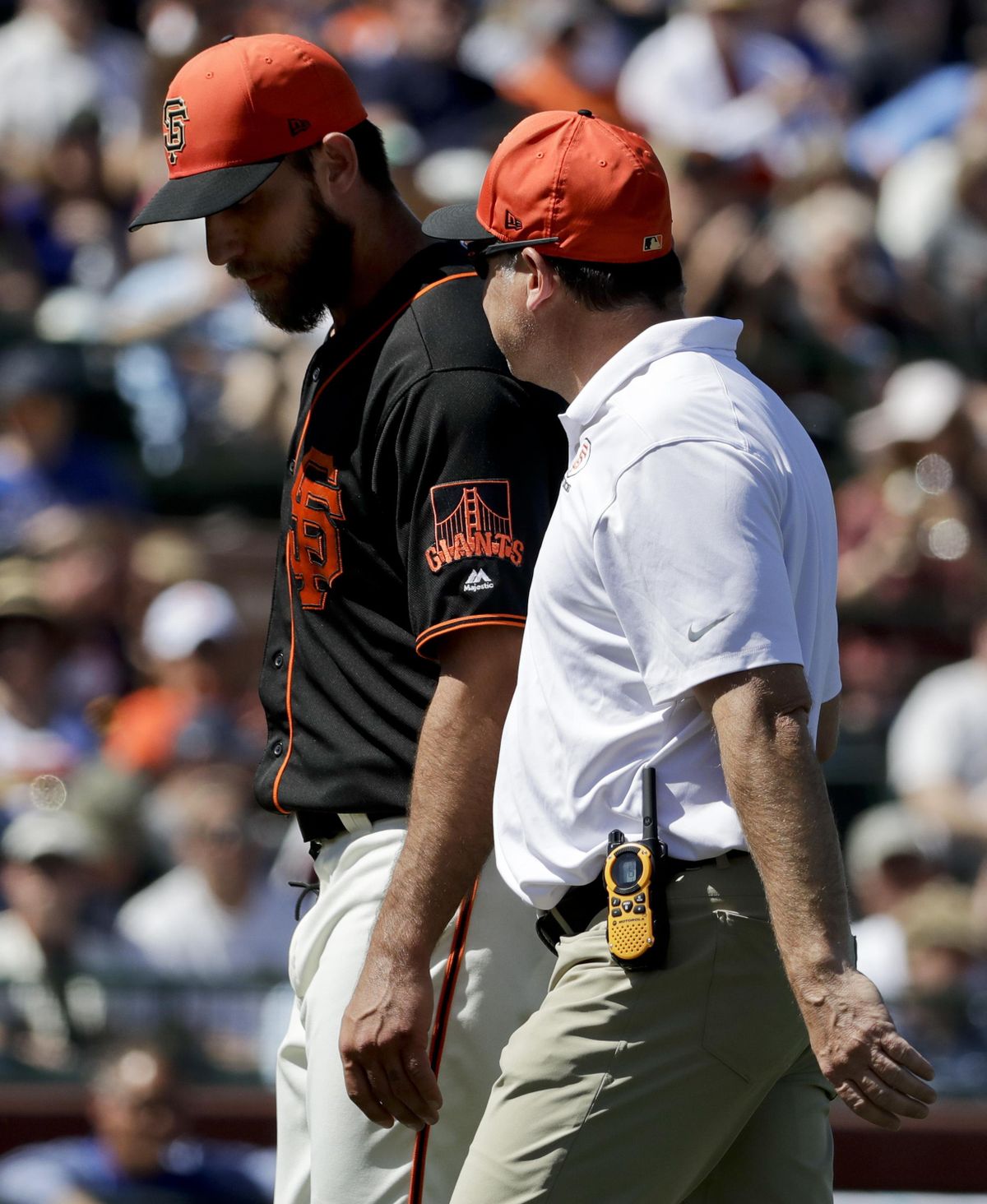 San Francisco Giants starting pitcher Madison Bumgarner is helped off the field after getting hit by a batted ball during the third inning of the team’s spring training baseball game against the Kansas City Royals in Scottsdale, Ariz., Friday, March 23, 2018. (Chris Carlson / Associated Press)