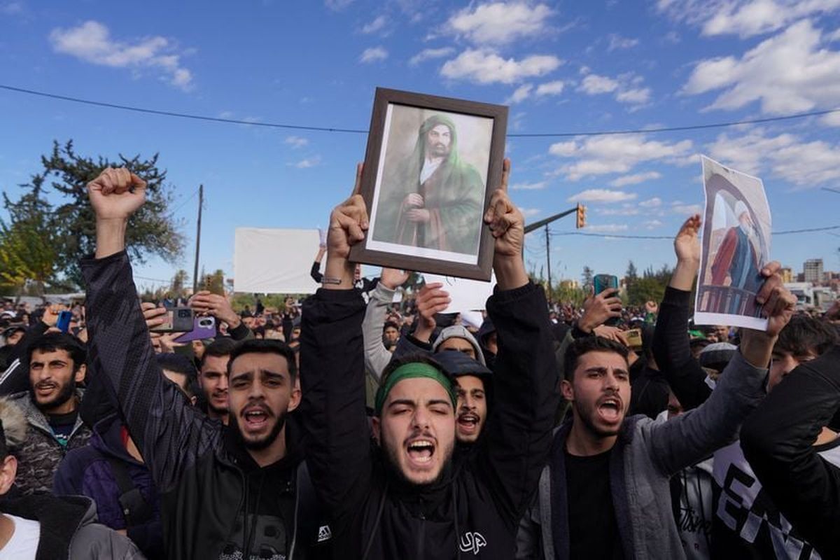 People from the Alawite sect protest as they demand federalism and an end to what they say is the killing and violations against Alawites on Sunday, in Latakia, Syria. (Reuters )