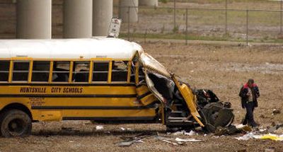 
An investigator works at the scene of a bus crash that killed three girls Monday in Huntsville, Ala. 
 (Associated Press / The Spokesman-Review)