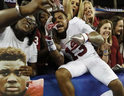 Alabama defensive back Nigel Knott celebrates with fans after the Southeastern Conference championship NCAA college football game against Florida, Saturday, Dec. 3, 2016, in Atlanta. Alabama won 54-16. (John Bazemore / Associated Press)