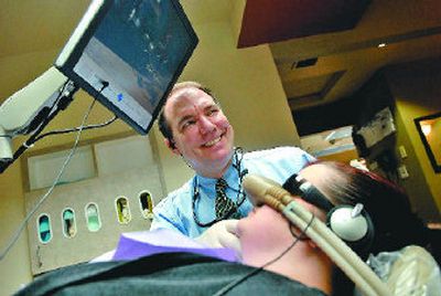 
Dr. George Loftus talks with his assistant at his office in Coeur d'Alene. He will take part in the first 