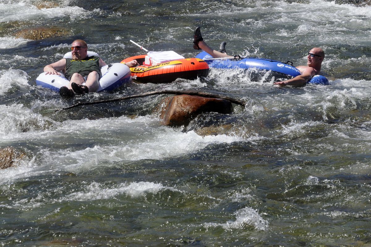  Exposed boulders at Flora Rapids on the Spokane River create an obstacle for river floaters below the Barker Bridge on Sunday.  The Spokane County Sheriff’s Office has adapted a zero-tolerance policy regarding its mandatory life jacket usage law.  (J. BART RAYNIAK)