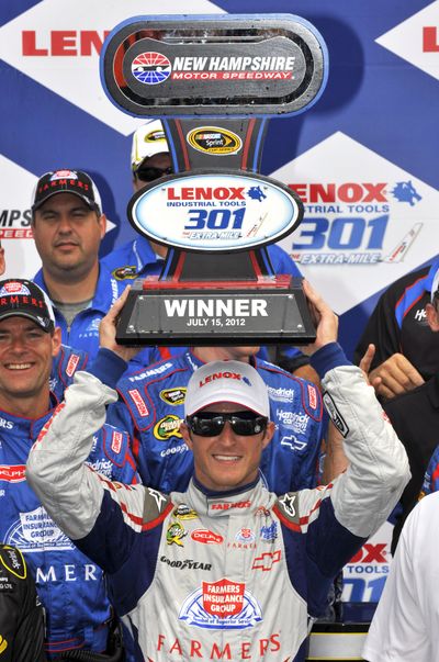 Kasey Kahne poses with the winner’s trophy on Sunday in New Hampshire. (Associated Press)