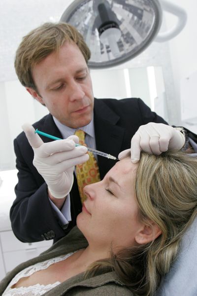 Dr. Jeffrey M. Kenkel gives Amy Andrade a Botox treatment at his office in the Northpark Mall in Dallas in November 2006. Botox treatments are among those that could be taxed.  (File Associated Press)