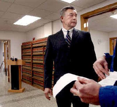 
A reporter looks over the report released by Kootenai County Prosecutor Bill Douglas on Monday at the Kootenai County Courthouse. The report justifies two sheriff's deputies' actions in a shooting that killed Michael Madonna and seriously injured Coeur d'Alene Police Officer Michael Kralicek. 
 (Kathy Plonka / The Spokesman-Review)