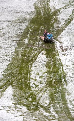 Reagan Calhoun, left, and Lindsy Camacho go sledding Friday, April 2, 2010 in Yakima, Wash. Only a dusting of snow fell in the morning in the Yakima area, just enough to slide on, before it turned to rain in the afternoon. (Gordon King / Yakima Herald-republic)