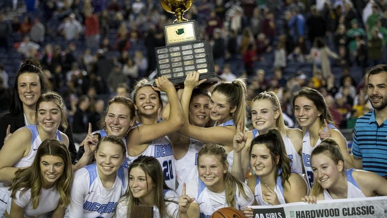 Members of Central Valley girls basketball pose for photos with the championship trophy after the State 4A title game on March 7 at the Tacoma Dome. (Patrick Hagerty/For The Spokesman Review)