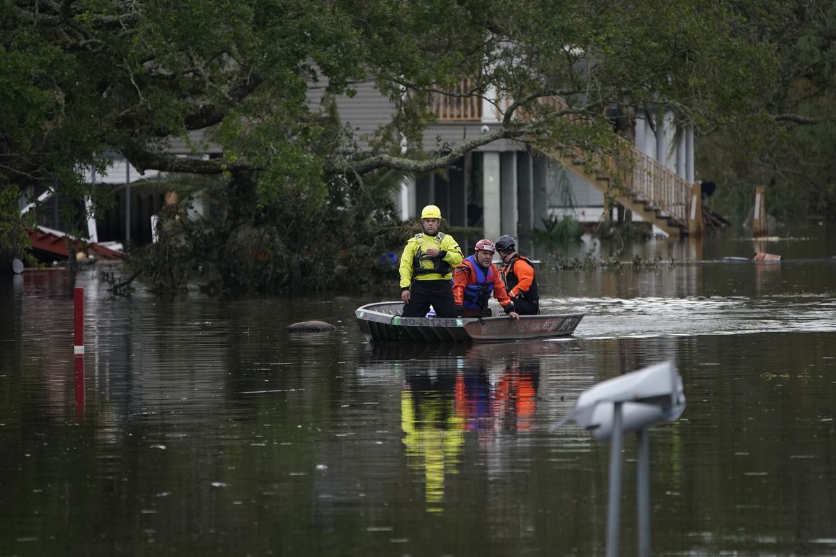 Animal rescue drive a boat down a flooded street in the aftermath of Hurricane Ida, Wednesday, Sept. 1, 2021, in Lafitte, La. Following Hurricane Ida, mutual aid networks sprang into action to supplement the more established relief services from federal and local governments, and charities.  (John Locher)