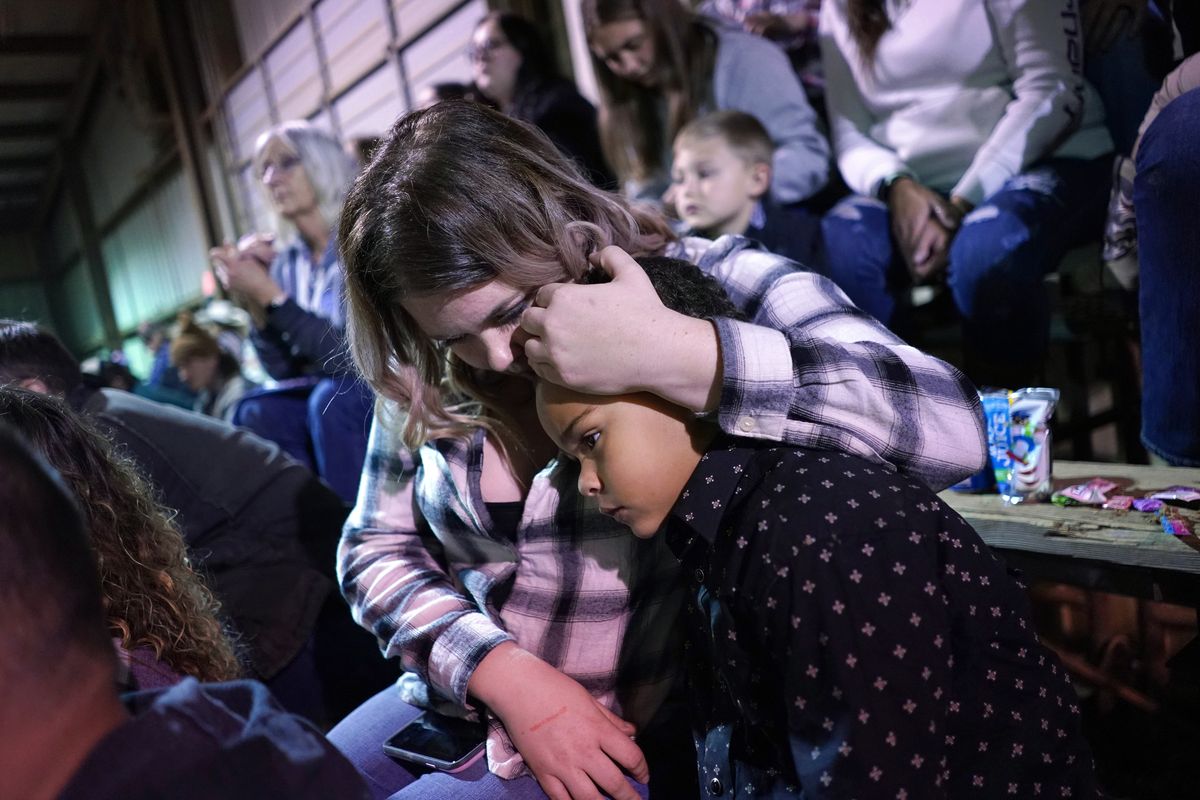 Amanda Paquette embraces her 7-year-old son, Preston Malvoisin, at the Rafter K Rodeo on March 4 in King, N.C.    (Matt McClain/The Washington Post)